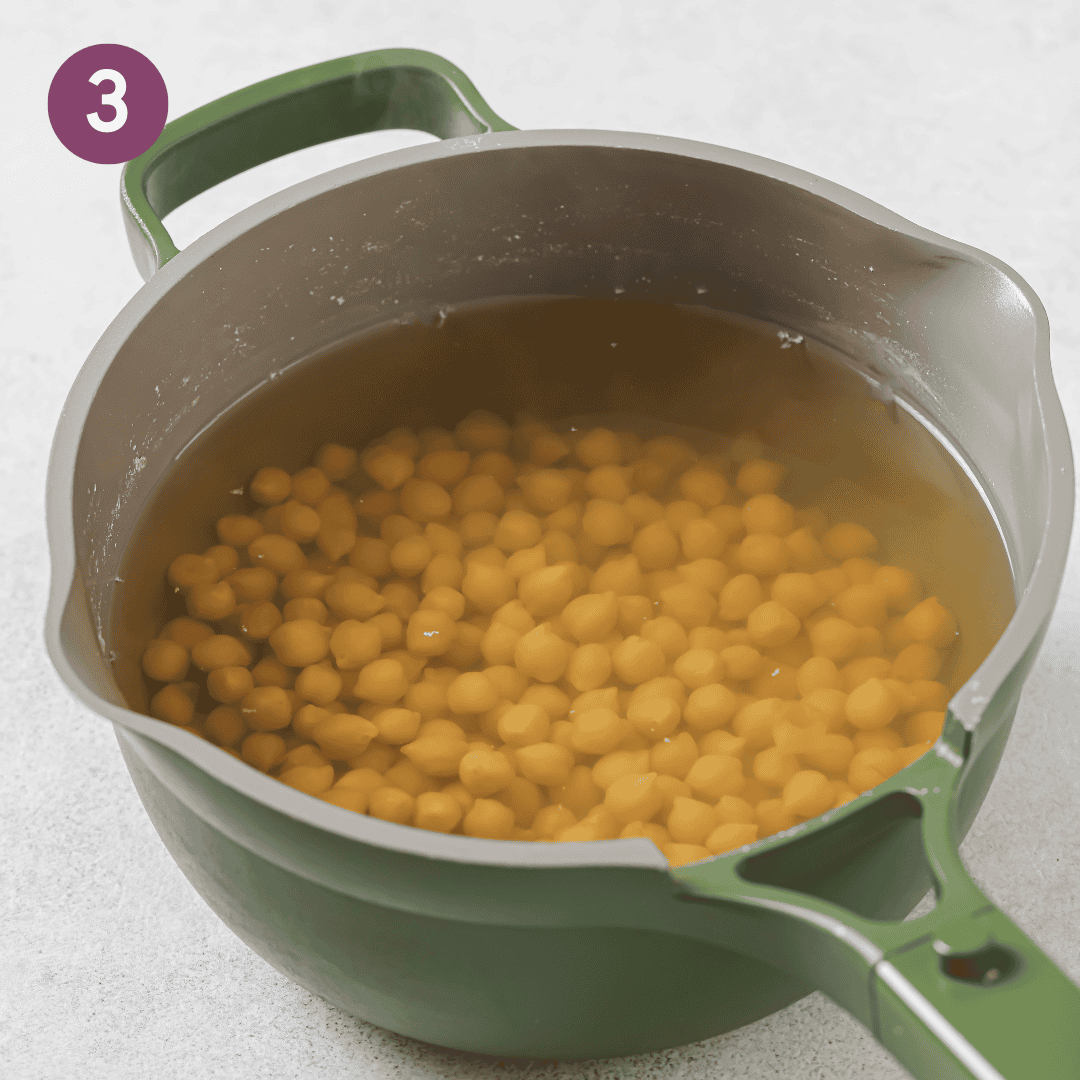 chickpeas halfway into being cooked in pot.