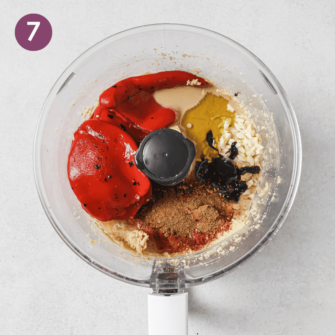 all ingredients for red pepper hummus in food processor before being blended.