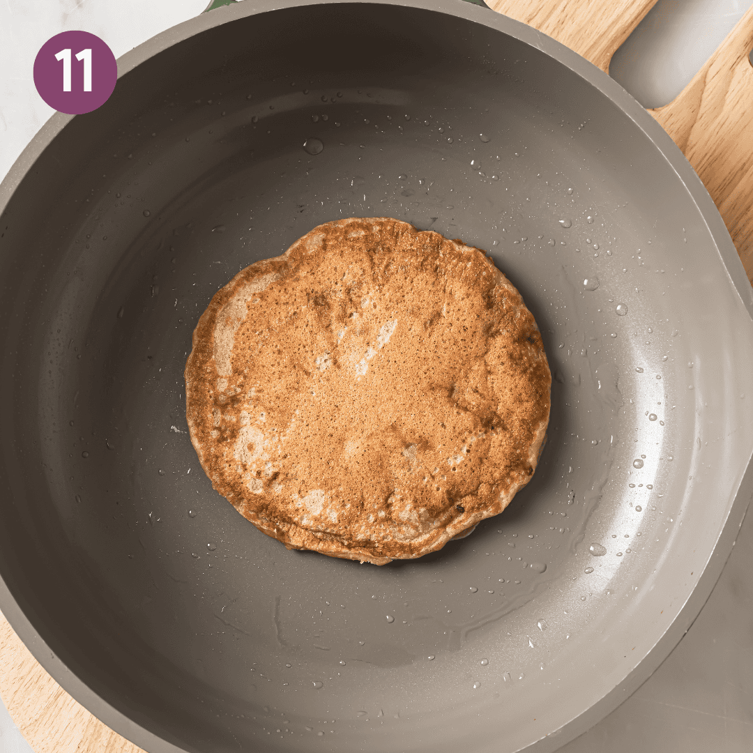 Flipped cooked pancake in skillet.
