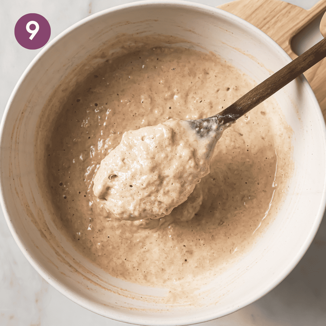 Person scooping up batter with a wooden spoon.