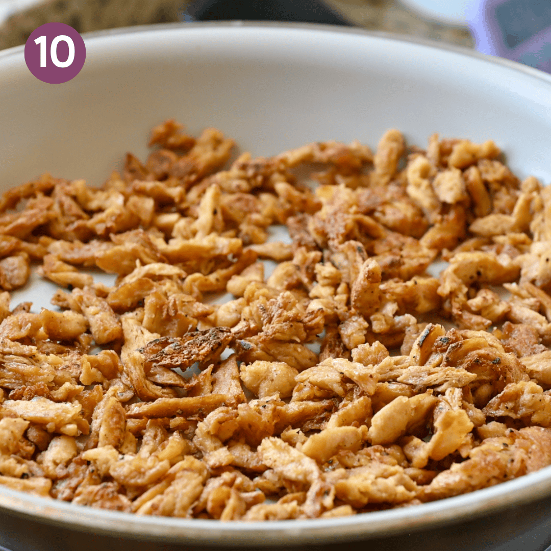 browned soy curls in frying pan after being cooked.