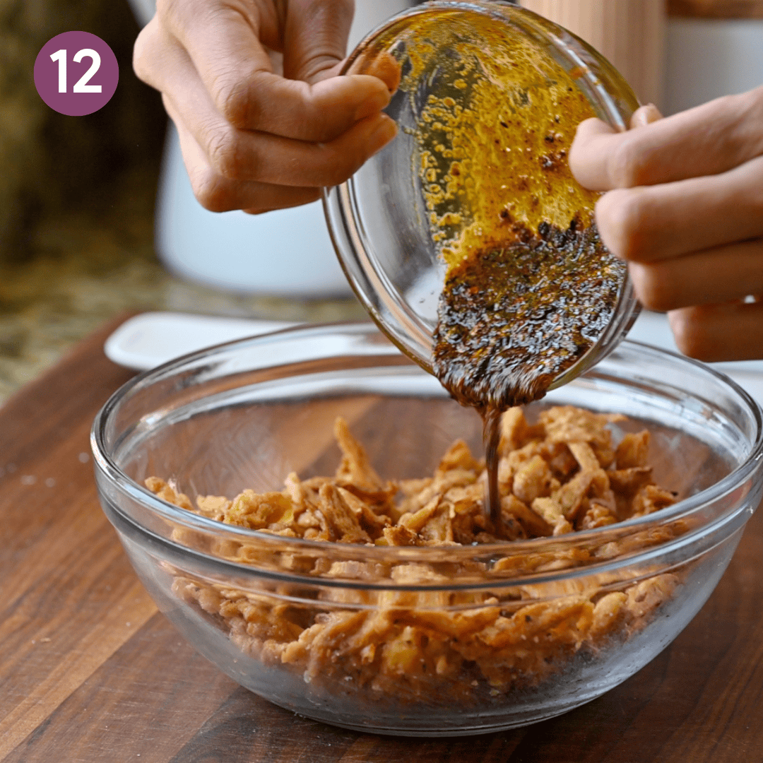 person pouring the tempered oil onto the soy curls.