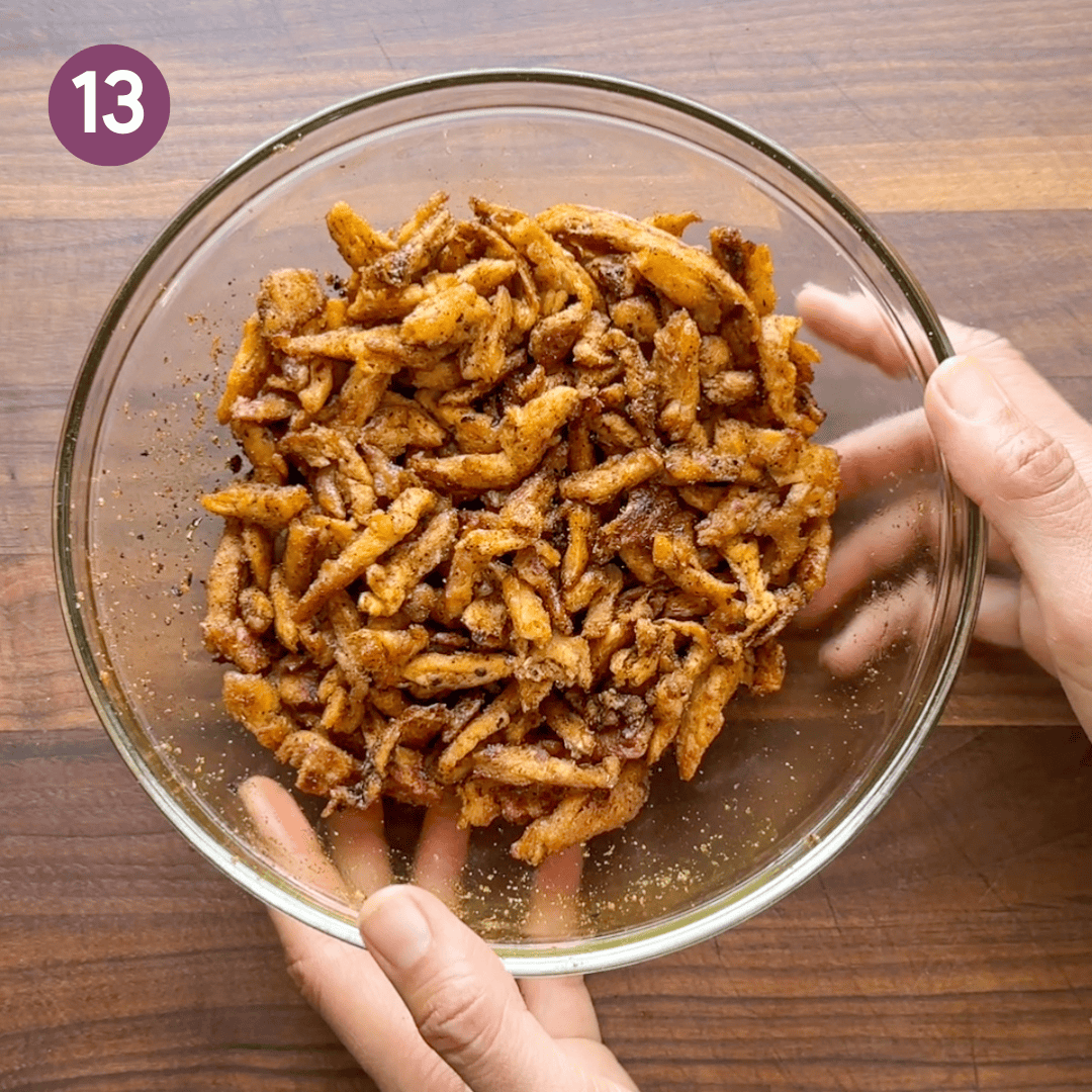 soy curls mixed with tempered oil in a glass bowl.