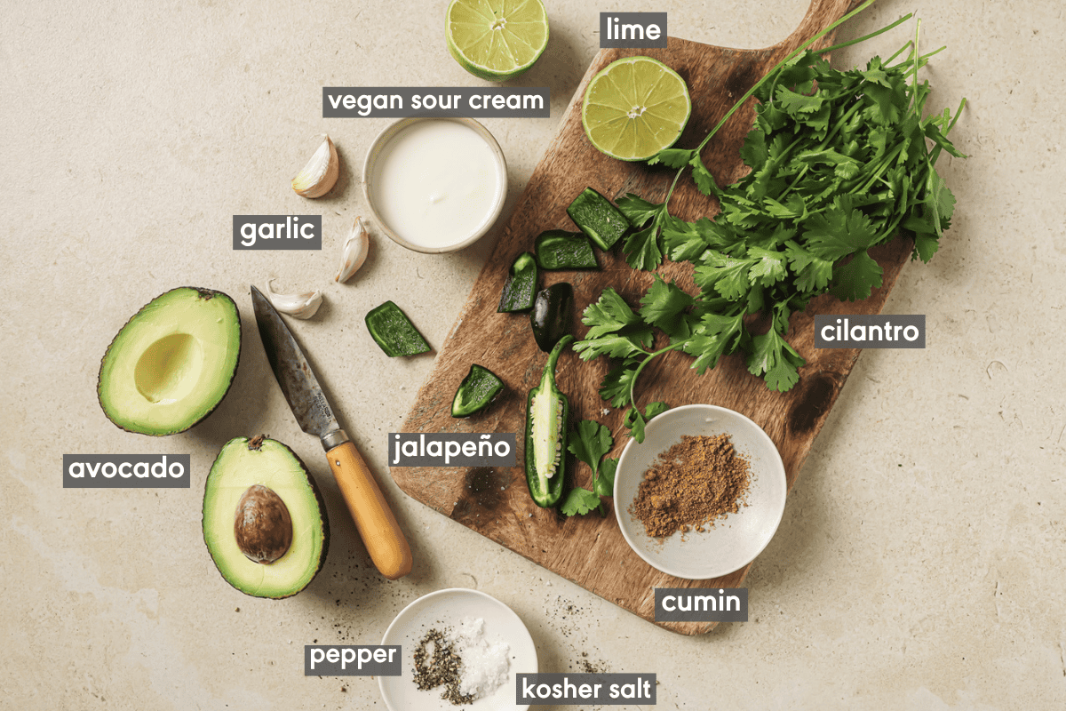 avocado crema ingredients on a cutting board and in various small bowls.