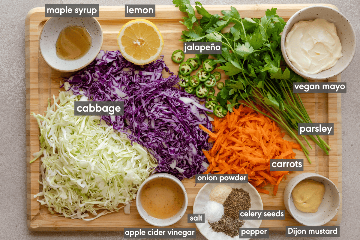 coleslaw ingredients on a wooden cutting board.