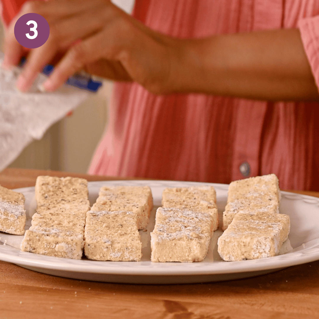 Plate of battered tofu before being cooked.