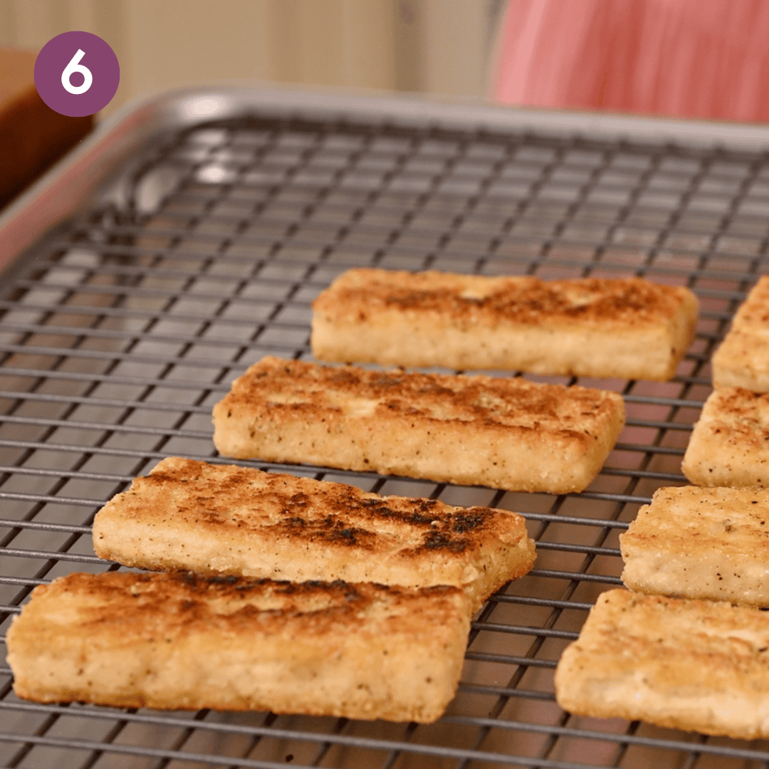 Crispy tofu slabs cooling on a wire rack.