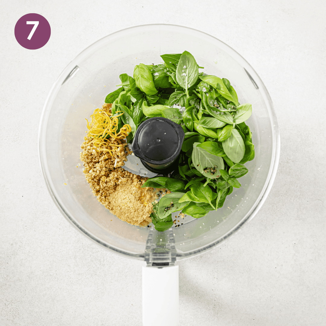 Ingredients for pesto in a food processor before being blended.