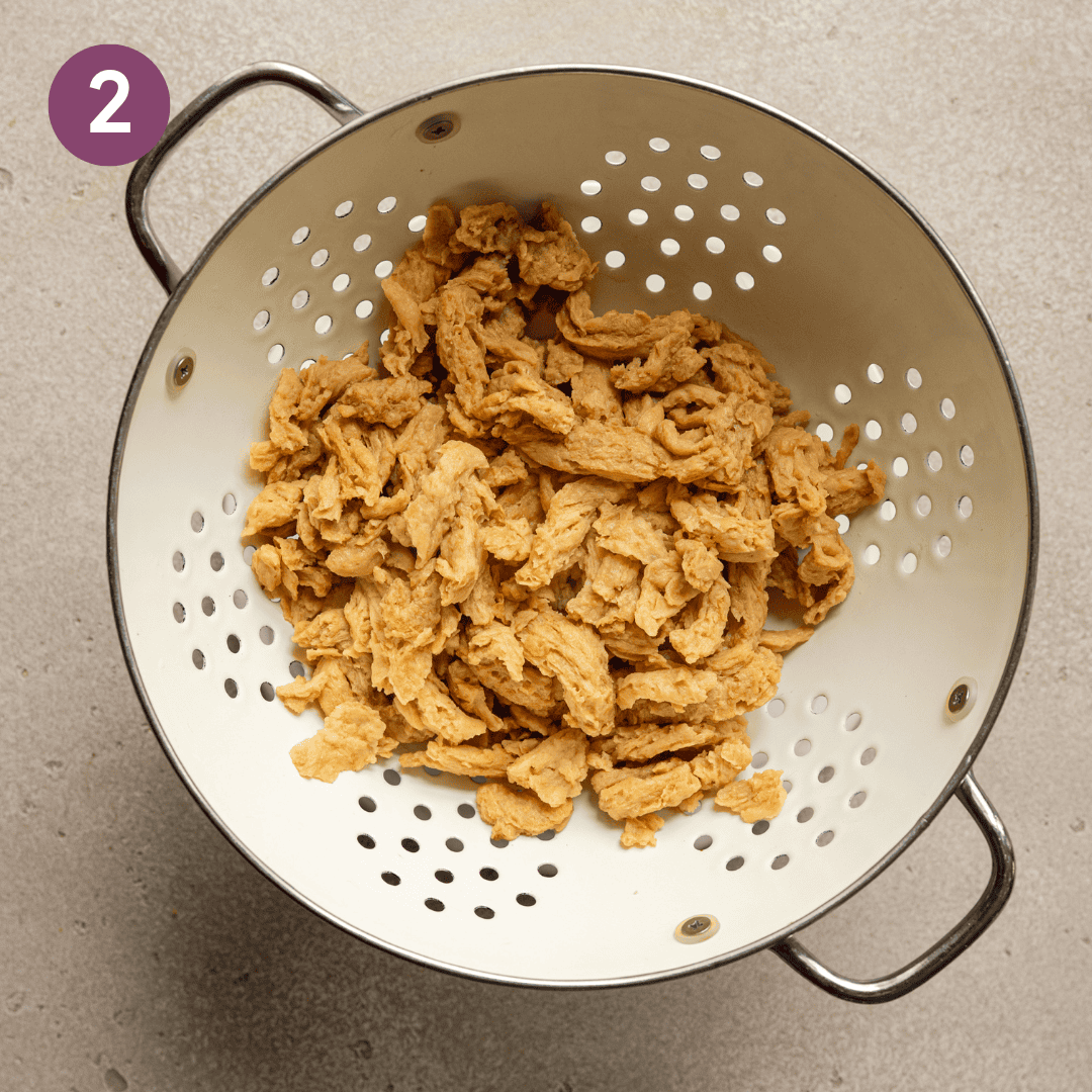 Soaked soy curls in a colander.
