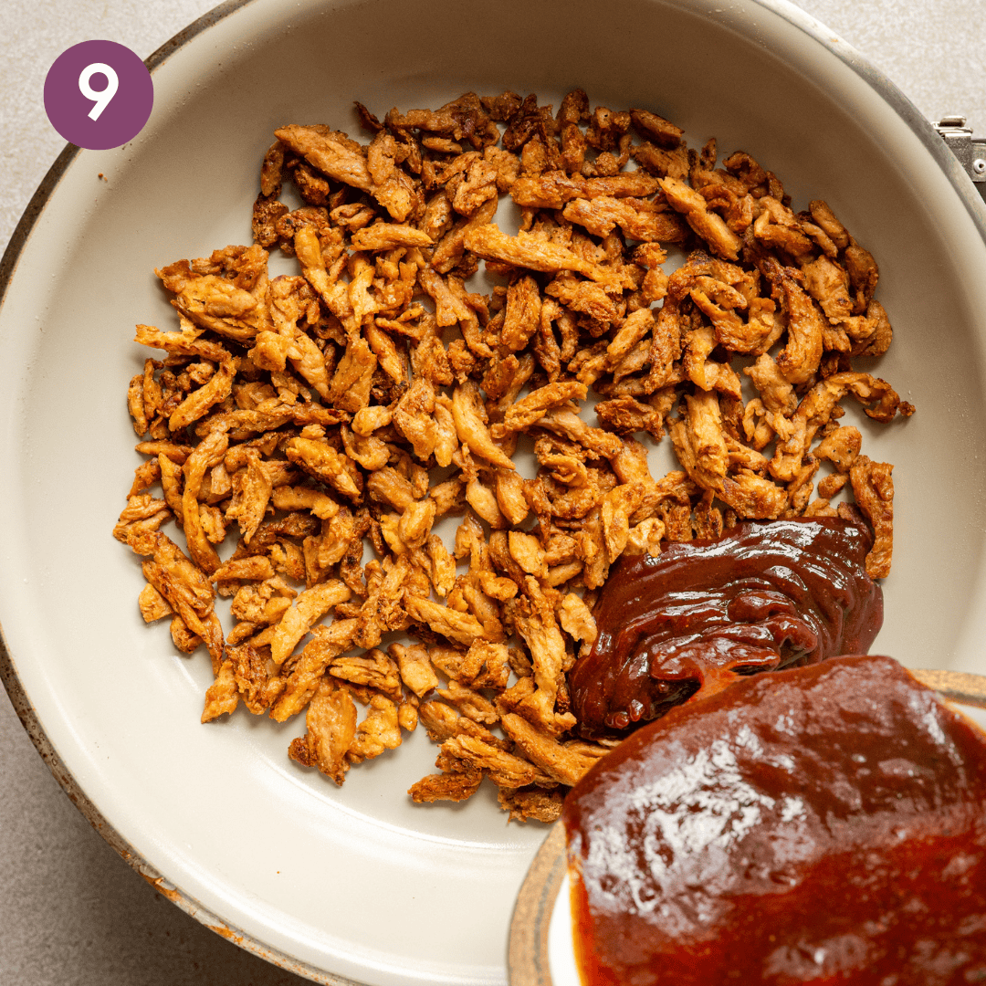 person pouring bbq sauce onto cooked soy curls in saucepan.