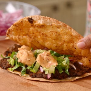 chipotle crema added to crispy black bean taco filling.