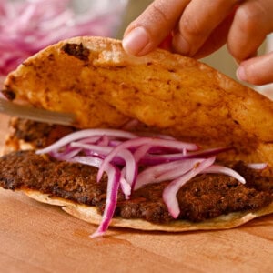 lime pickled onions in crispy black bean tacos.
