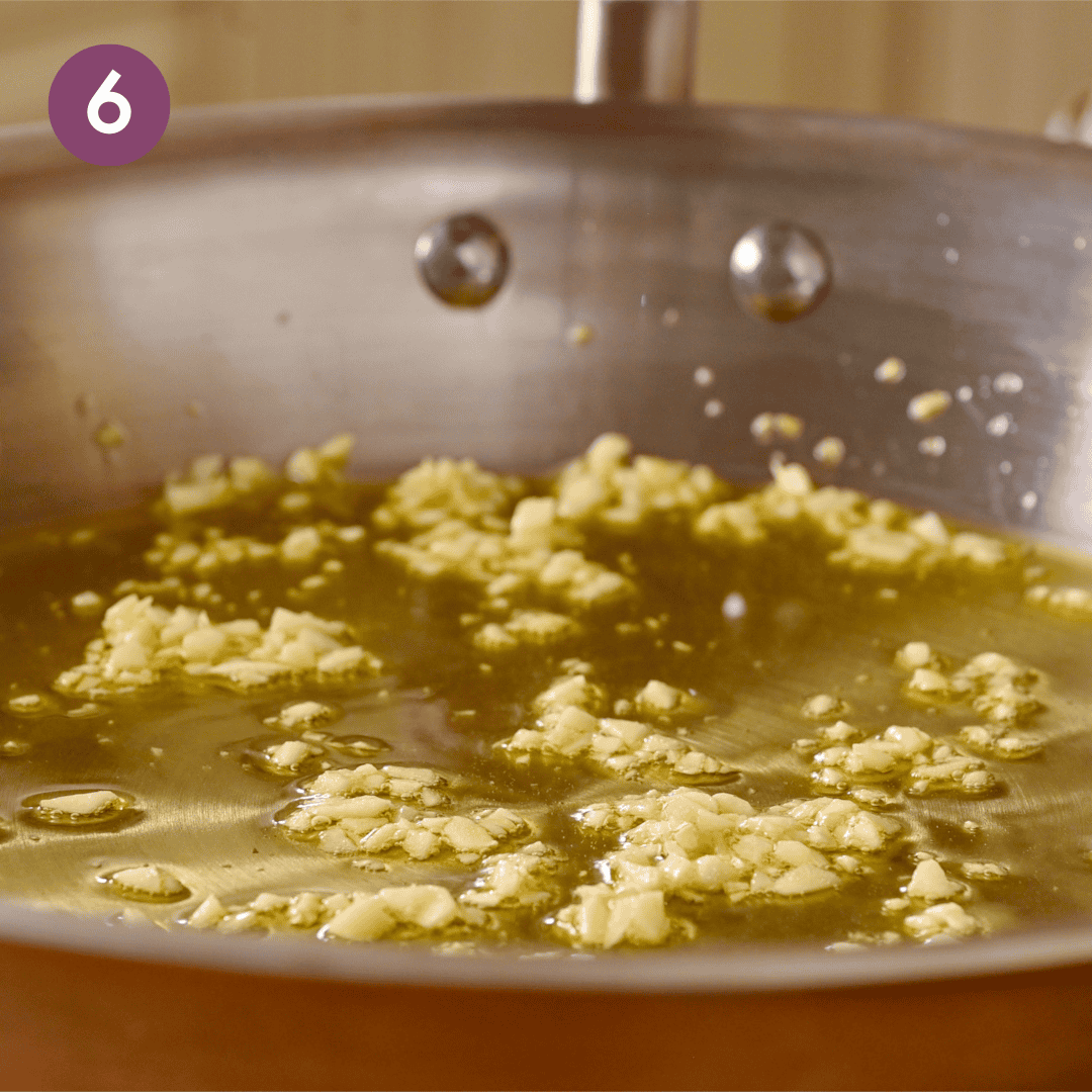 garlic and oil in a saute pan while being cooked.
