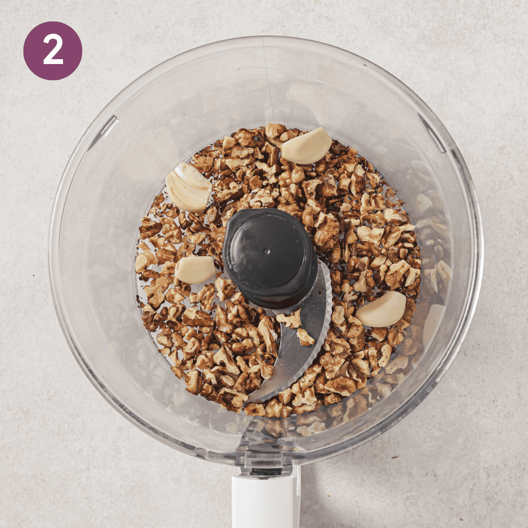 walnuts and garlic in a food processor before being pulsed into a fine crumb.