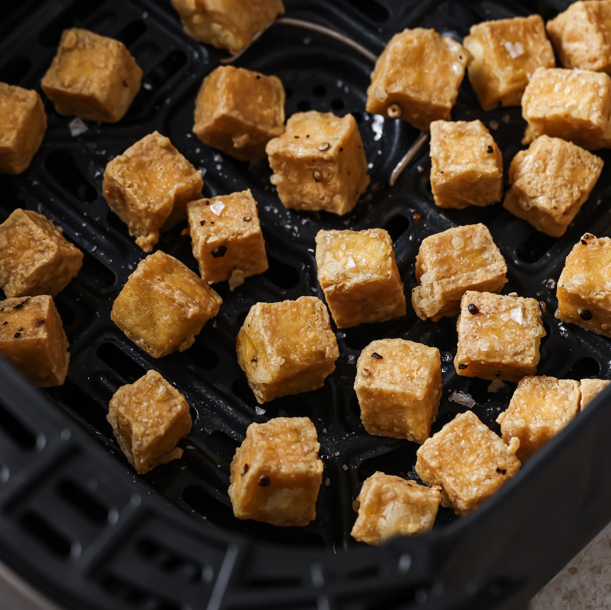 cooked tofu cubes in air fryer.