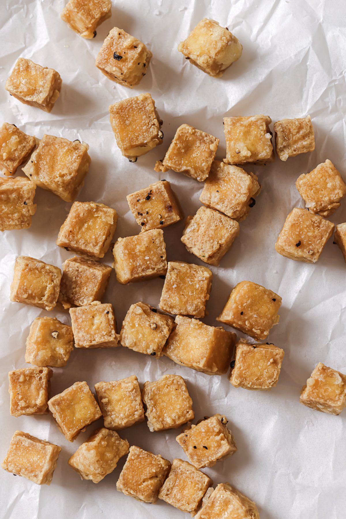 cooked tofu cubes on parchment paper.