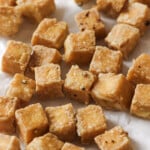 close up of tofu cubes on a paper towel.