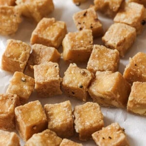 close up of tofu cubes on a paper towel.