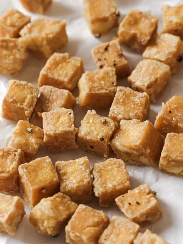 close up of tofu cubes on a paper towel.