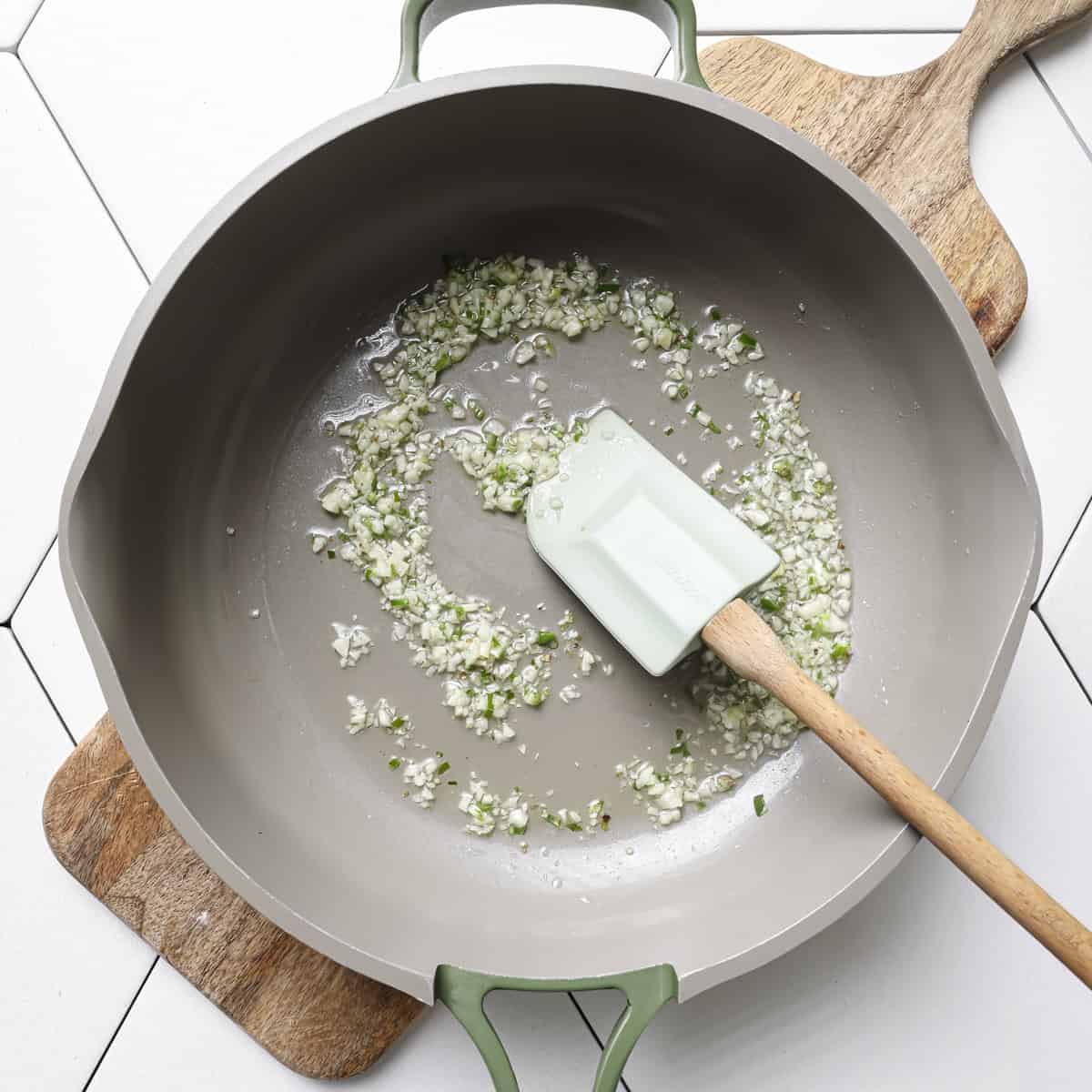 garlic and serrano pepper with oil in a saucepan.