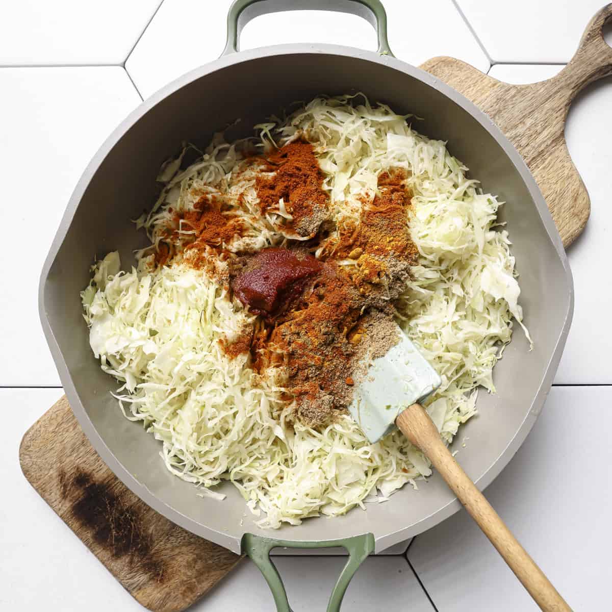 tomato paste and ground spices added to the cooked cabbage.