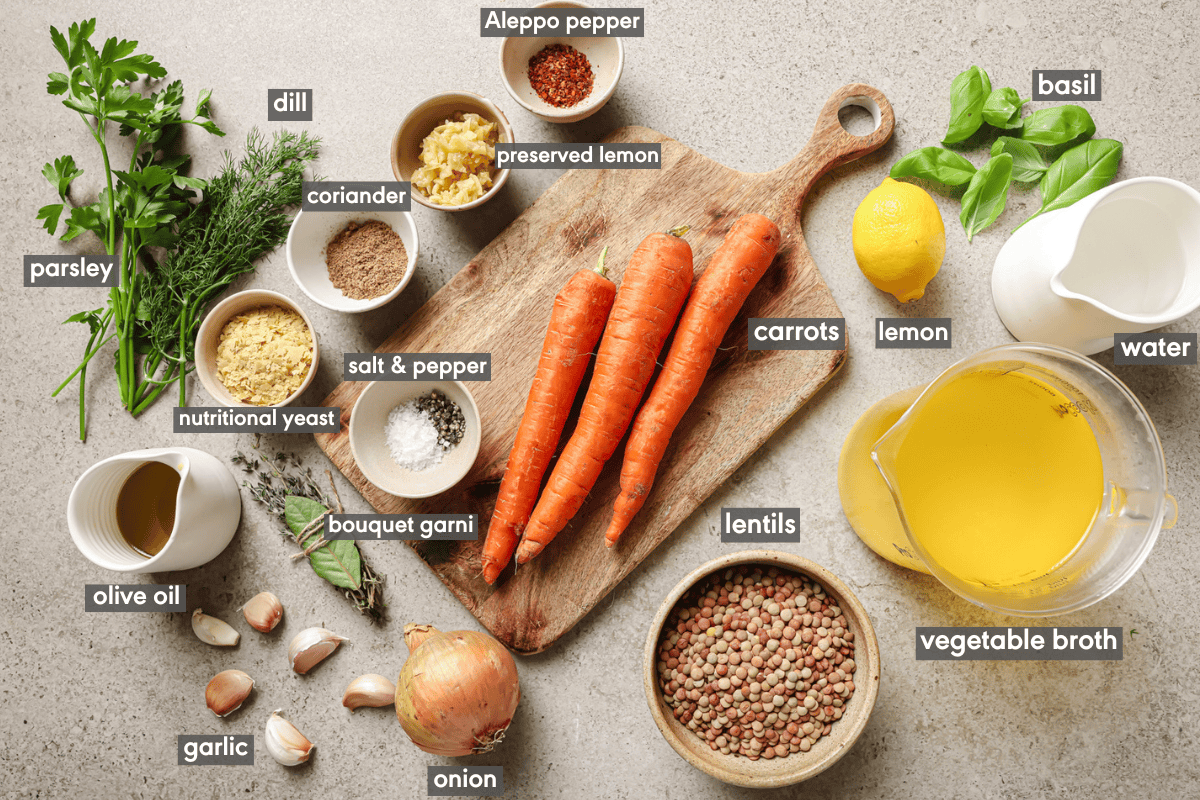 various ingredients for lentil soup in small bowls and spread out on a table.