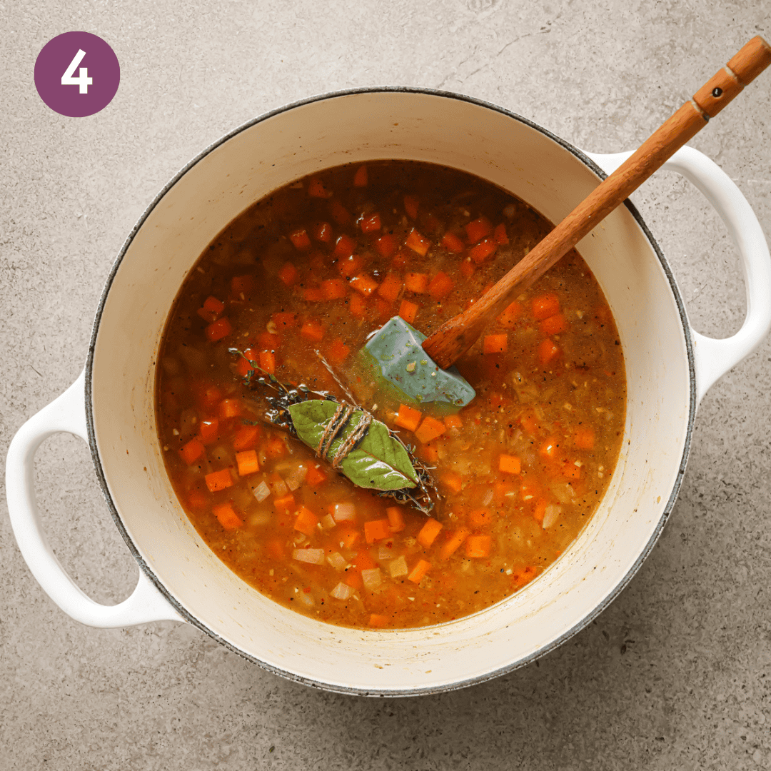 vegetable broth, lentils, water and bouquet garni added to the a pot of sauteed aromatics.