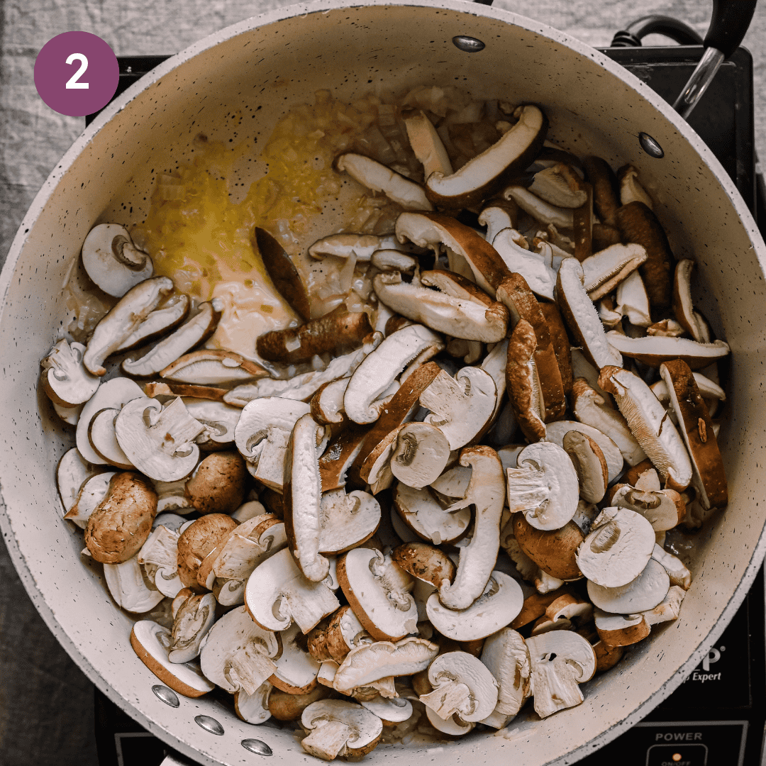 mushrooms added to shallot oil mixture in pan.