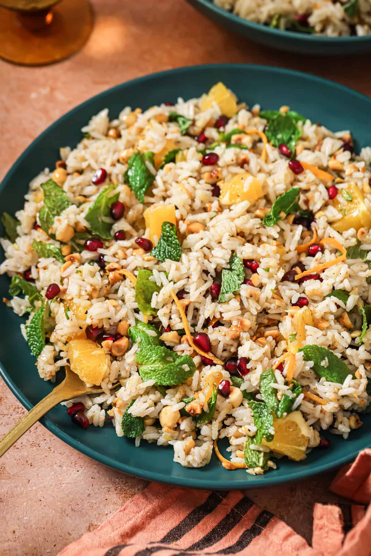 overhead view of filled bowl of herbed rice salad on a table.