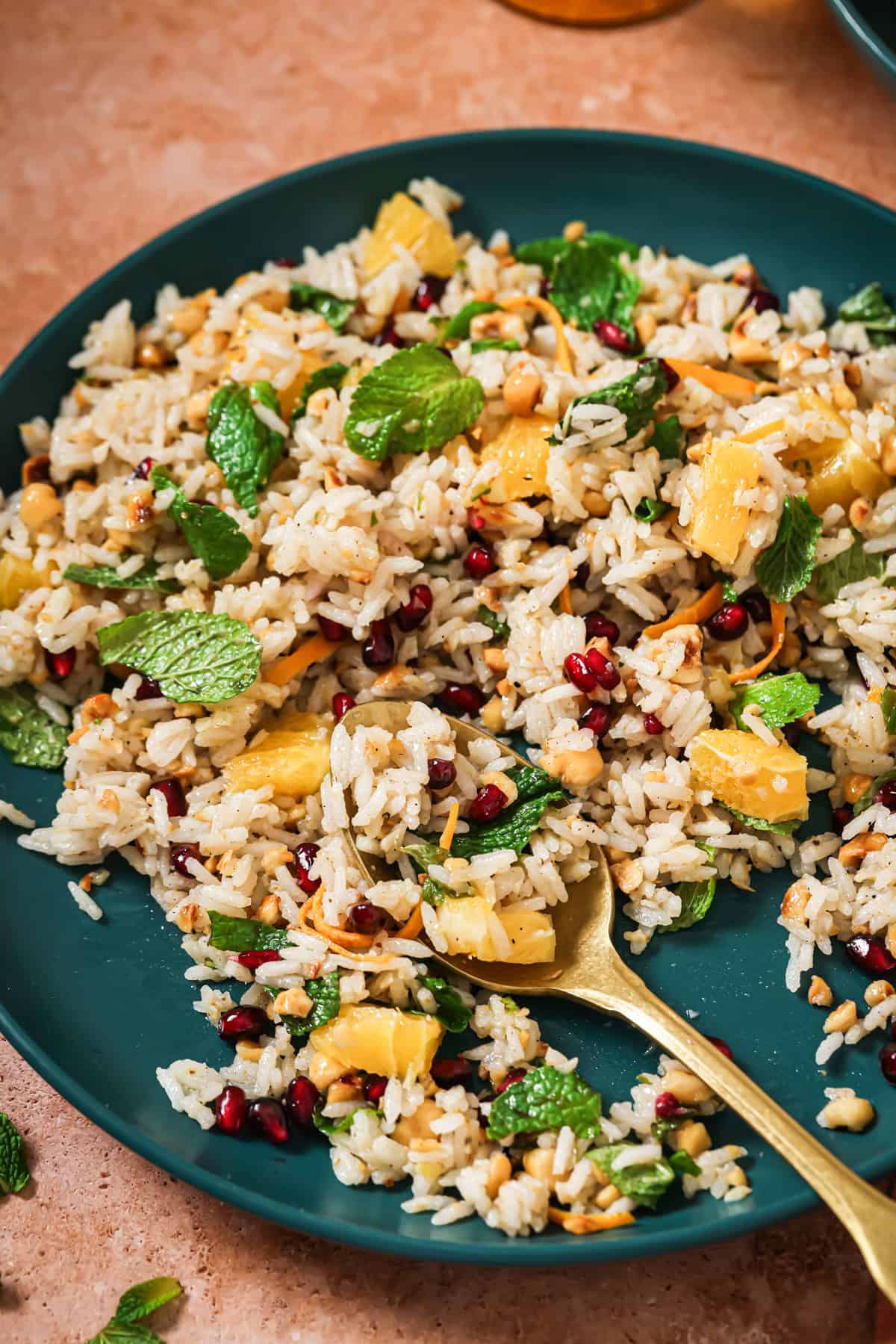 close up of spoon in a plate of herbed rice salad.
