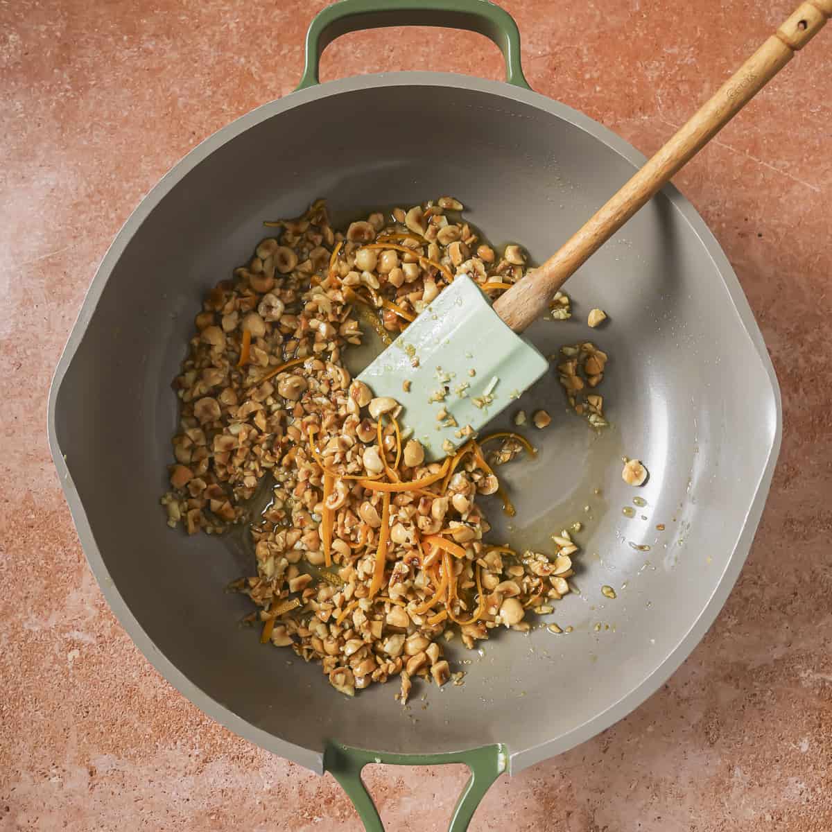 orange peel added to the garlic and hazelnuts in the pan.