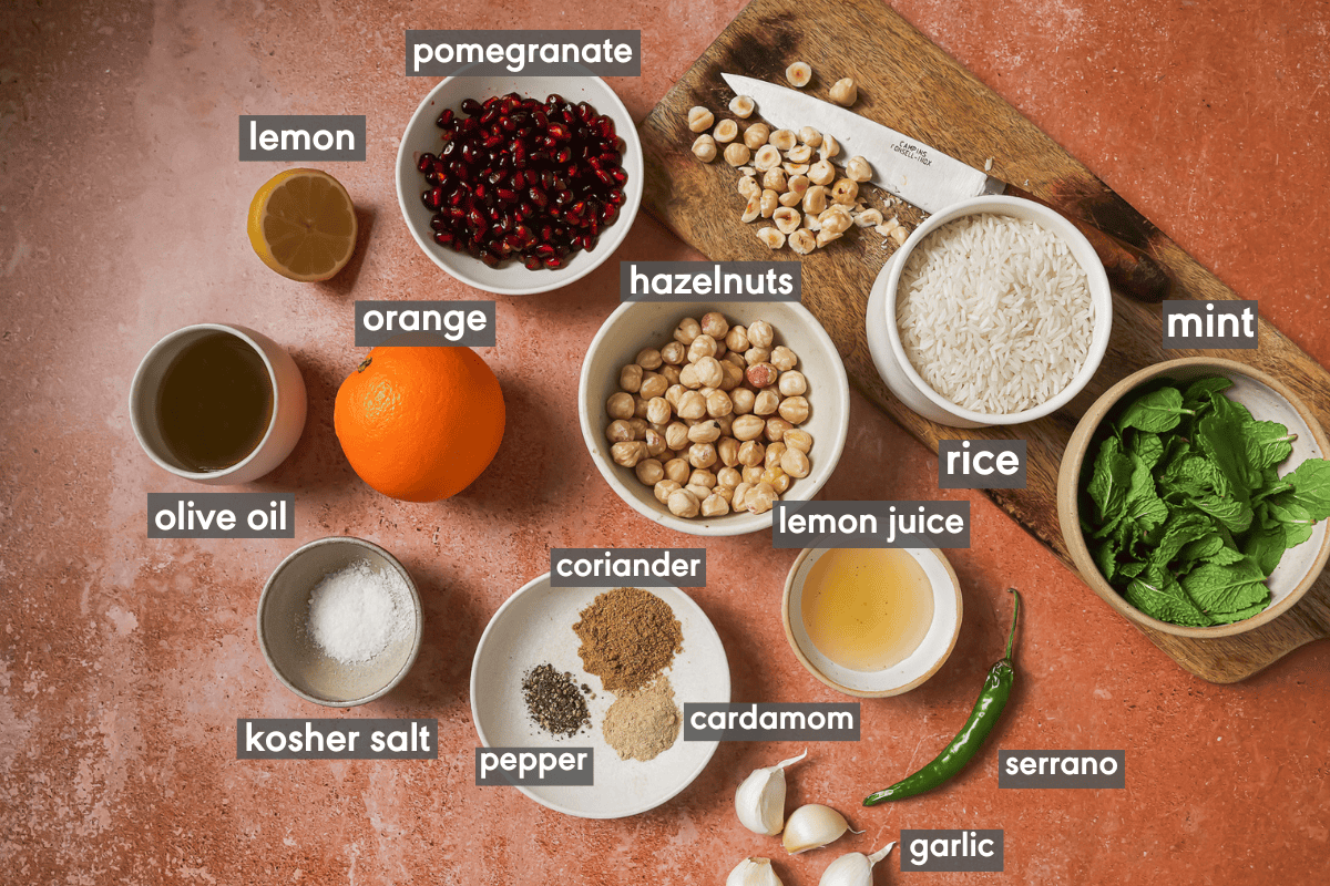 ingredients in various small bowls on a table for herbed rice salad.