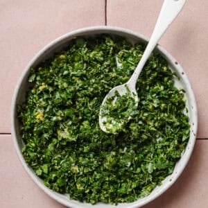 gremolata in a bowl with a spoon.