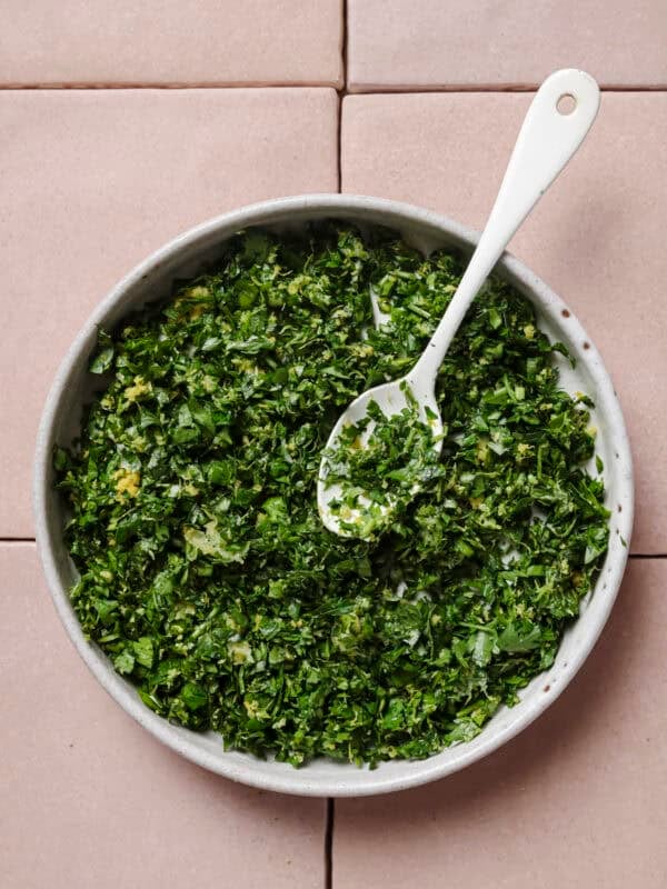 gremolata in a bowl with a spoon.