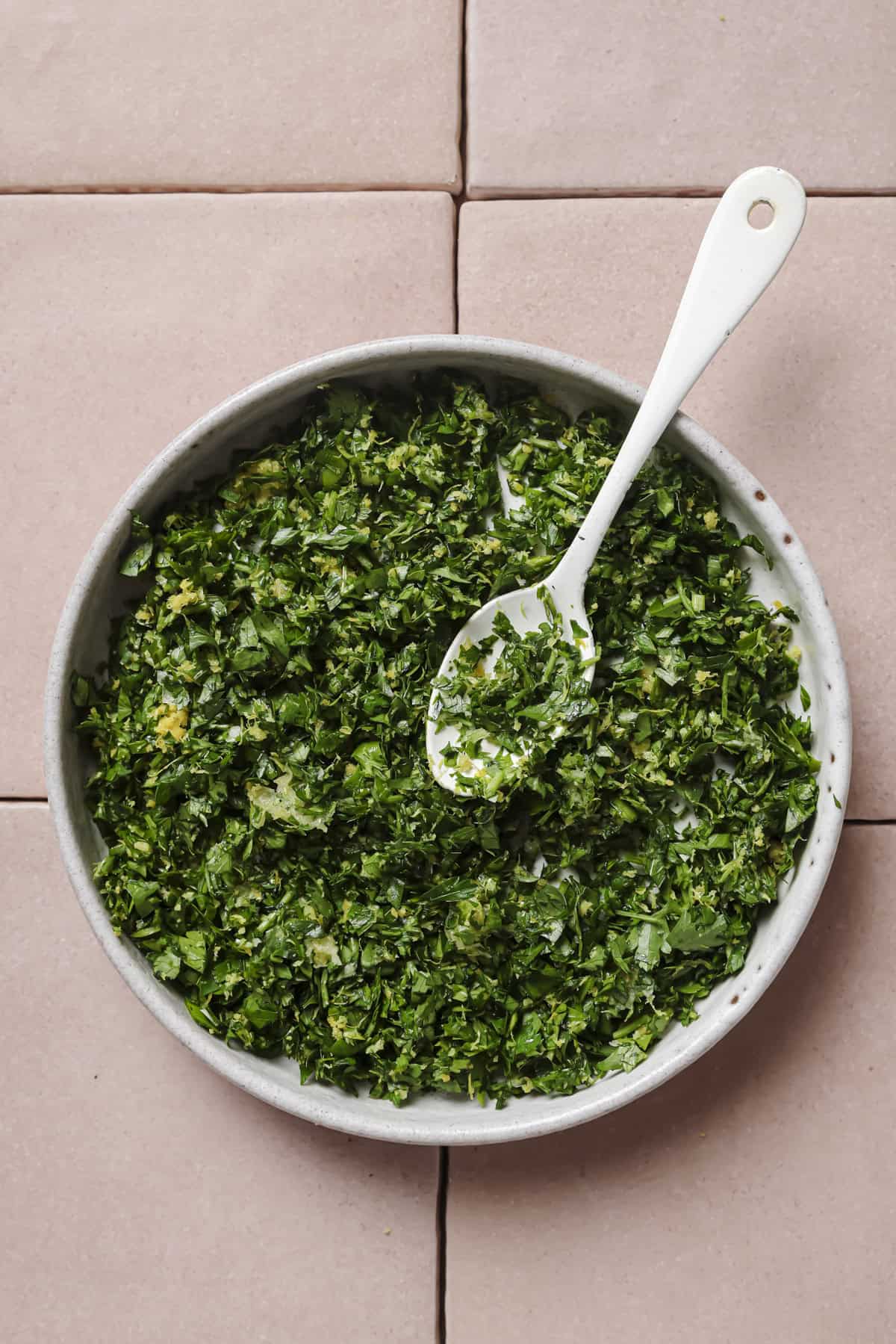 gremolata in a bowl with a spoon.