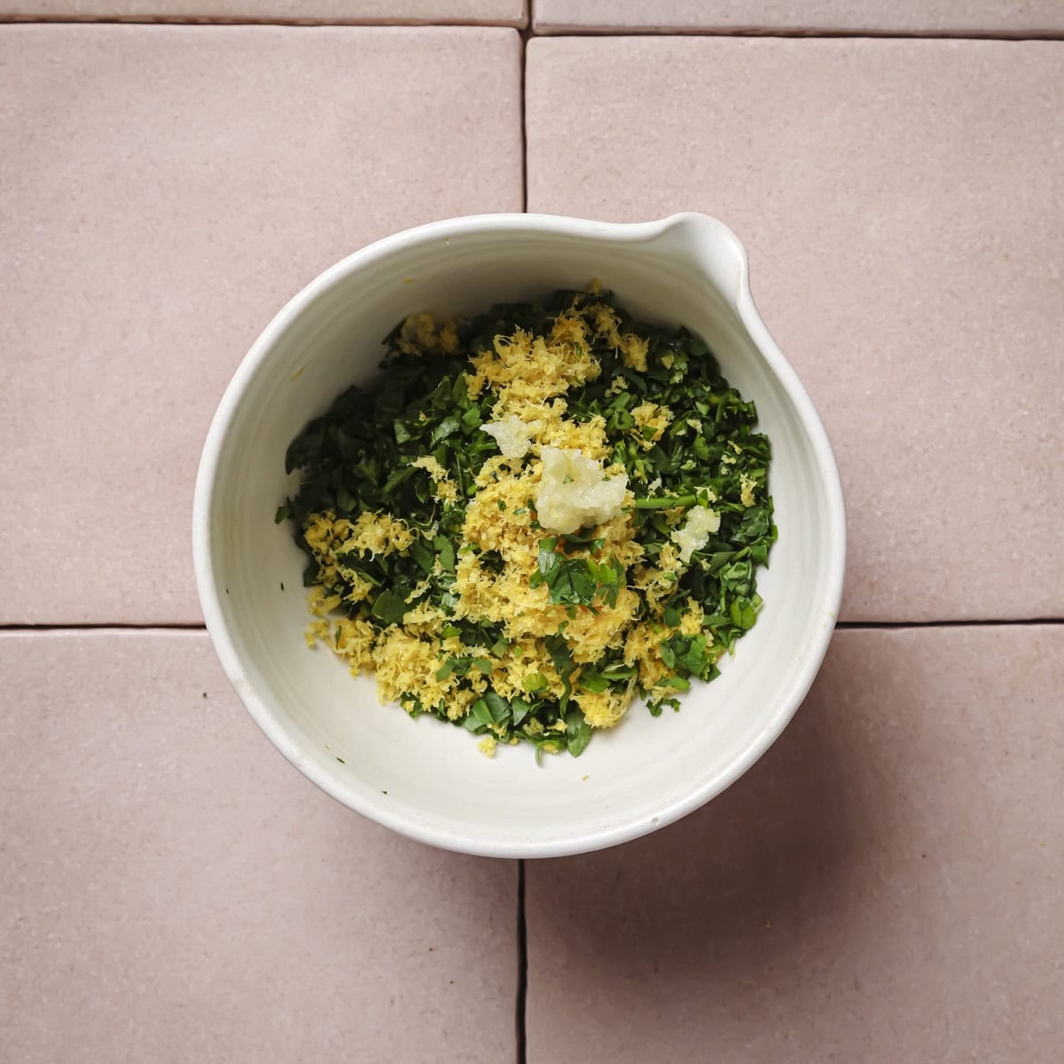 garlic grated on top of the lemon zest and parsley.