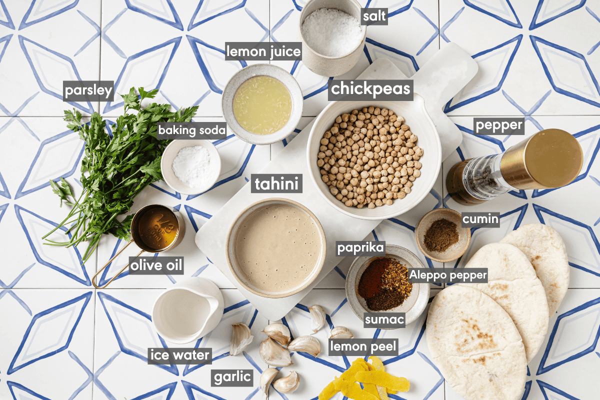 ingredients for hummus in various small bowls on a table.