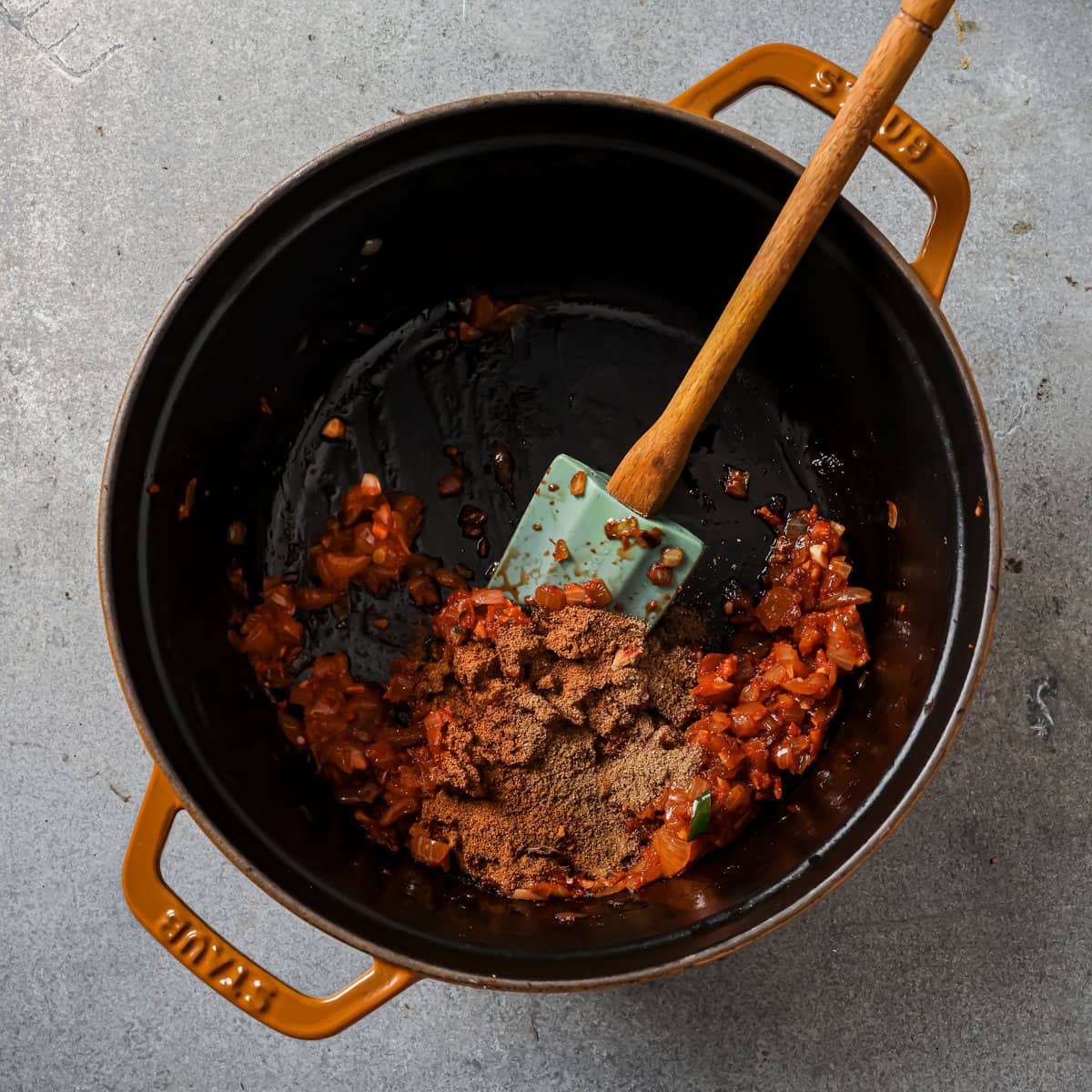 ras el hanout, coriander, and cumin added to the tomato aromatic mixture.