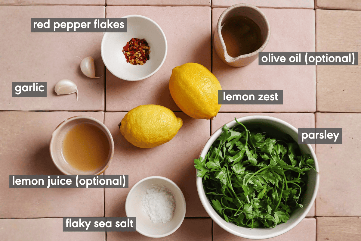gremolata ingredients in various small bowls on a table.