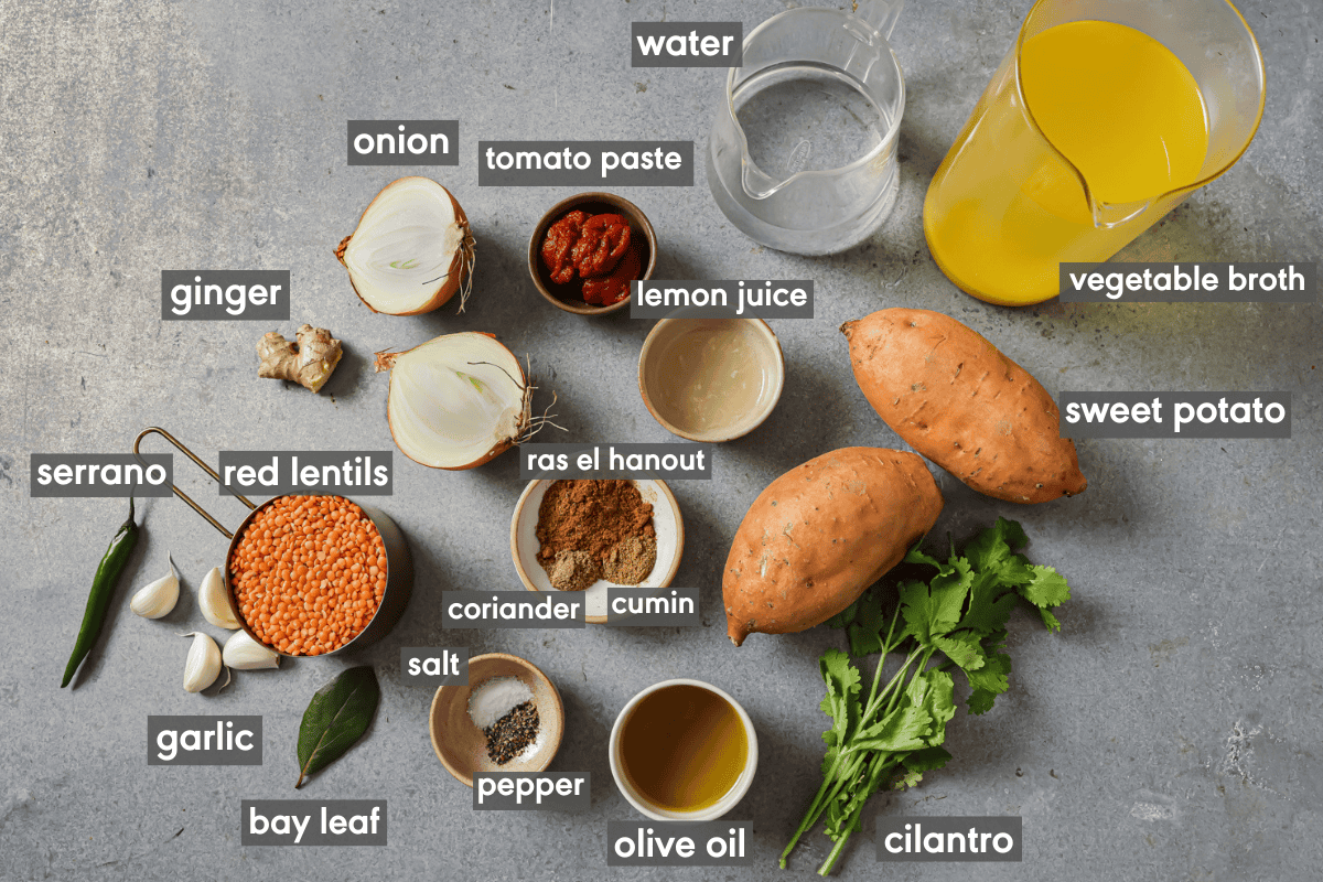 ingredients for red lentil curry in various small bowls on a table.