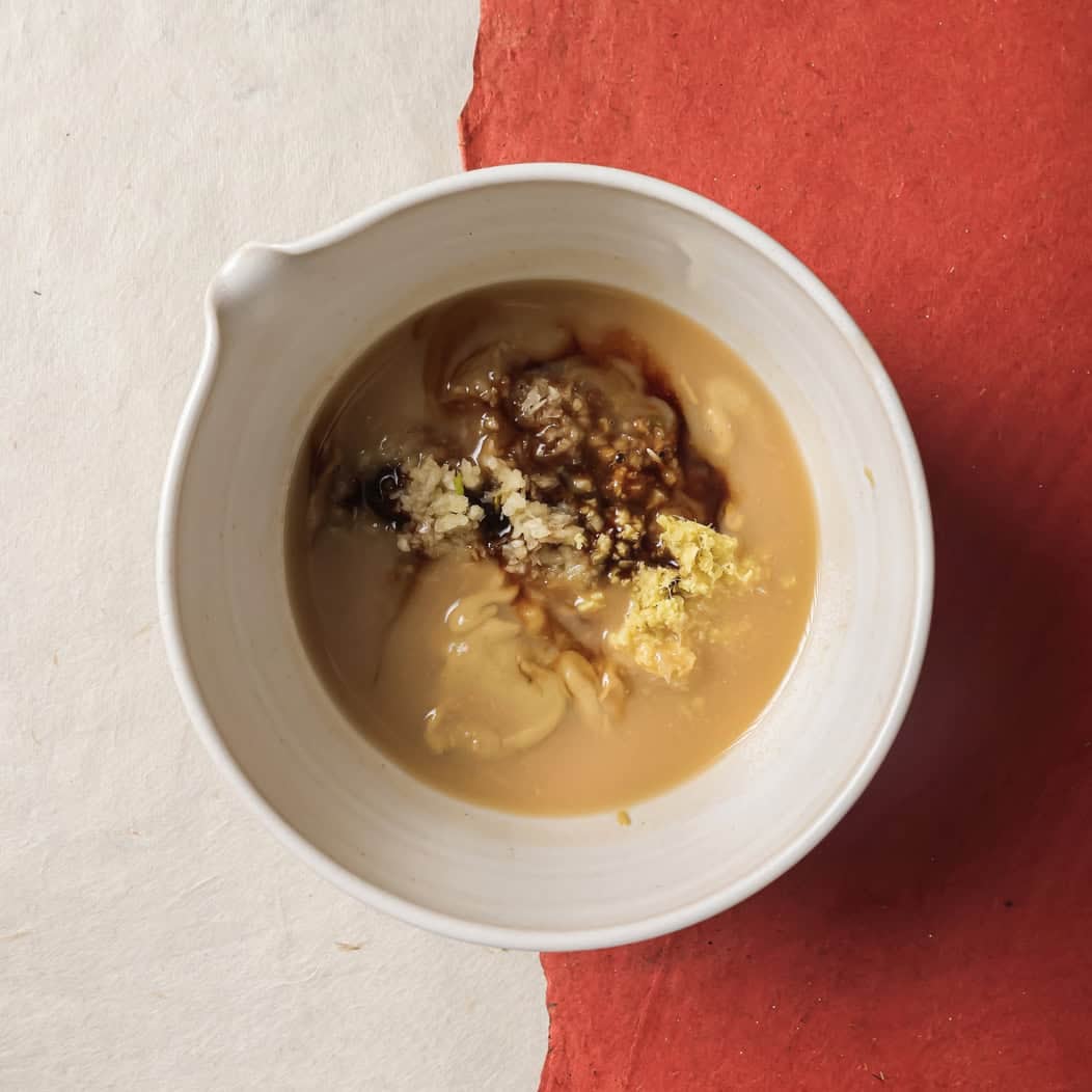 garlic, ginger, maple syrup, Dijon mustard, and soy sauce added to the whisked miso and vinegar.