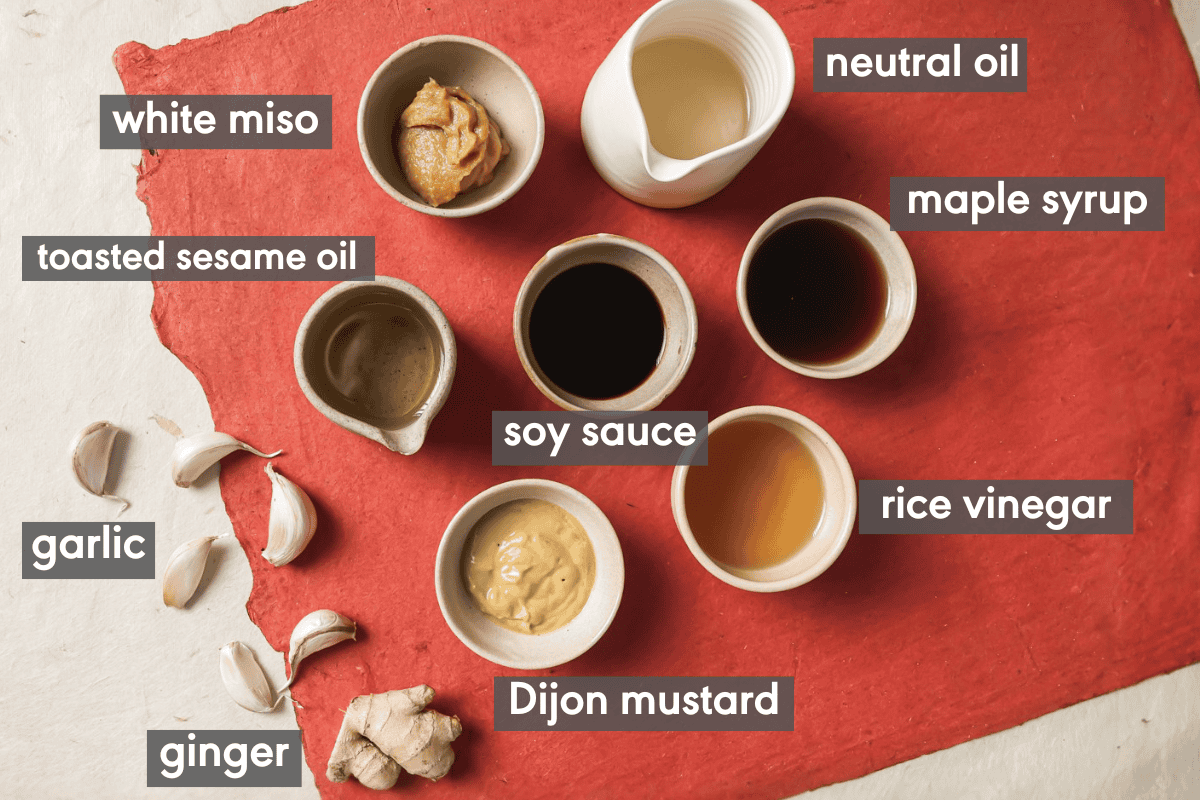 sesame miso dressing ingredients in various small bowls on a table.