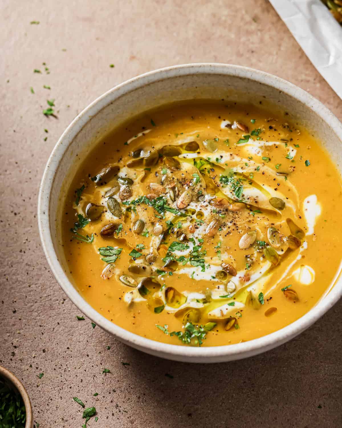 bowl of soup topped with roasted pepitas.