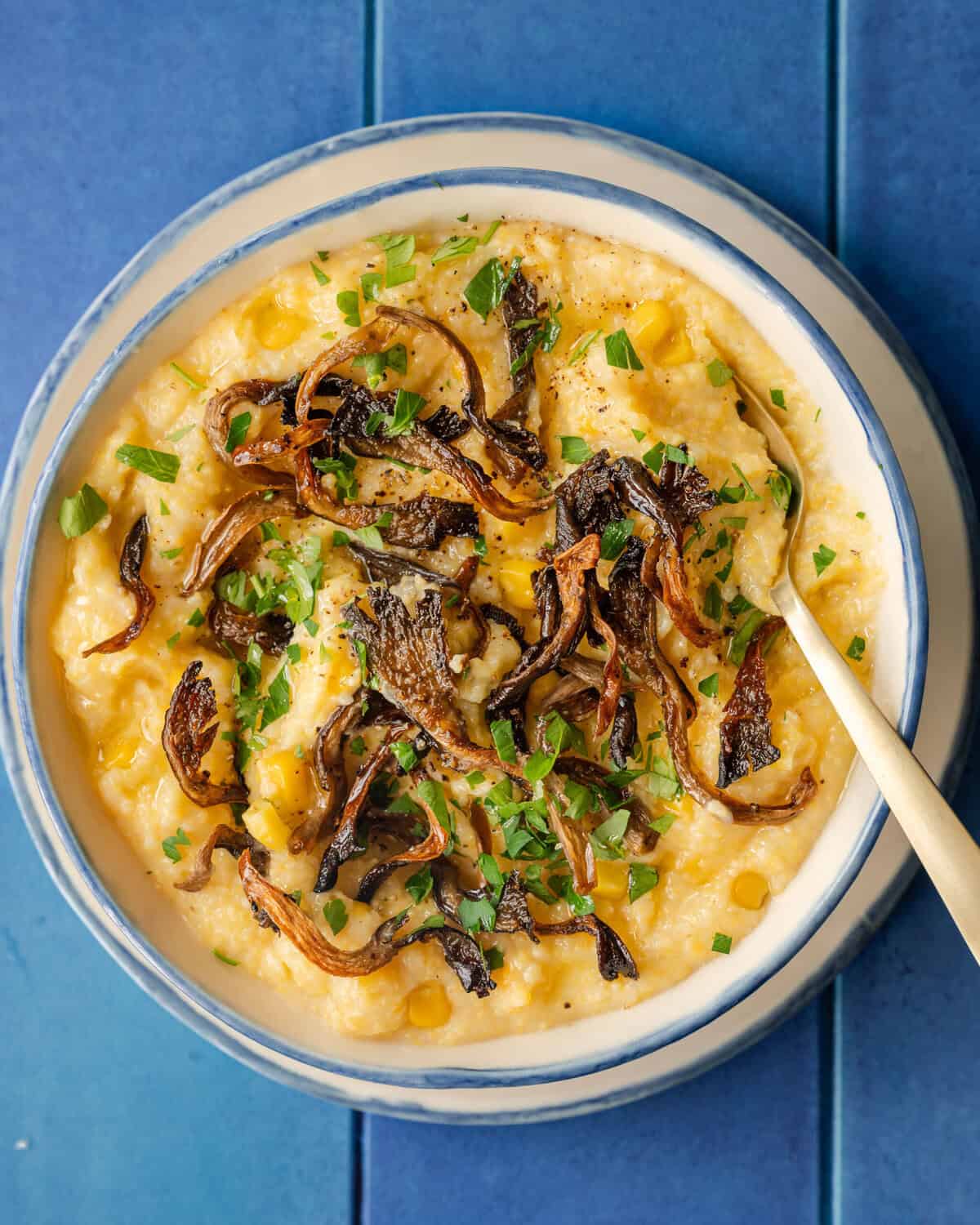 roasted mushrooms on a bowl of polenta.