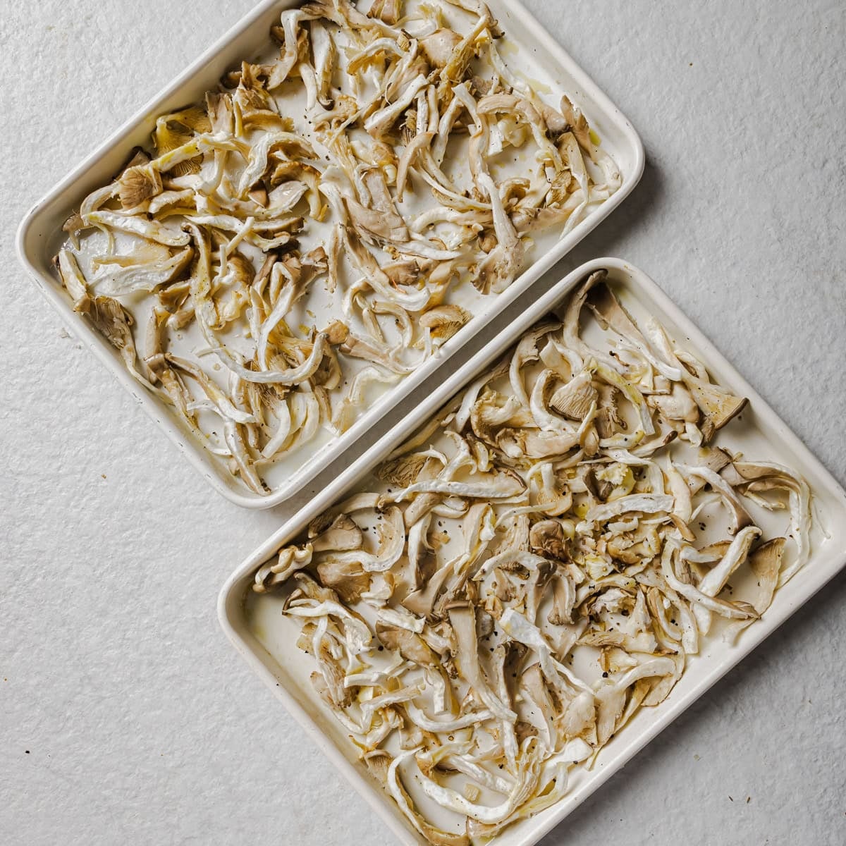 mushrooms spread out on two sheet pans.