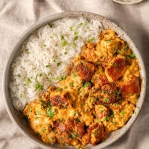 overhead view of tofu curry with rice in a bowl.