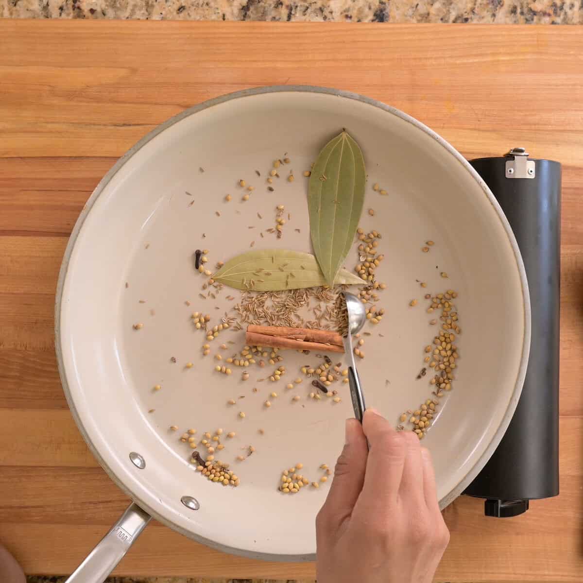 cumin seeds added to pan to toast.