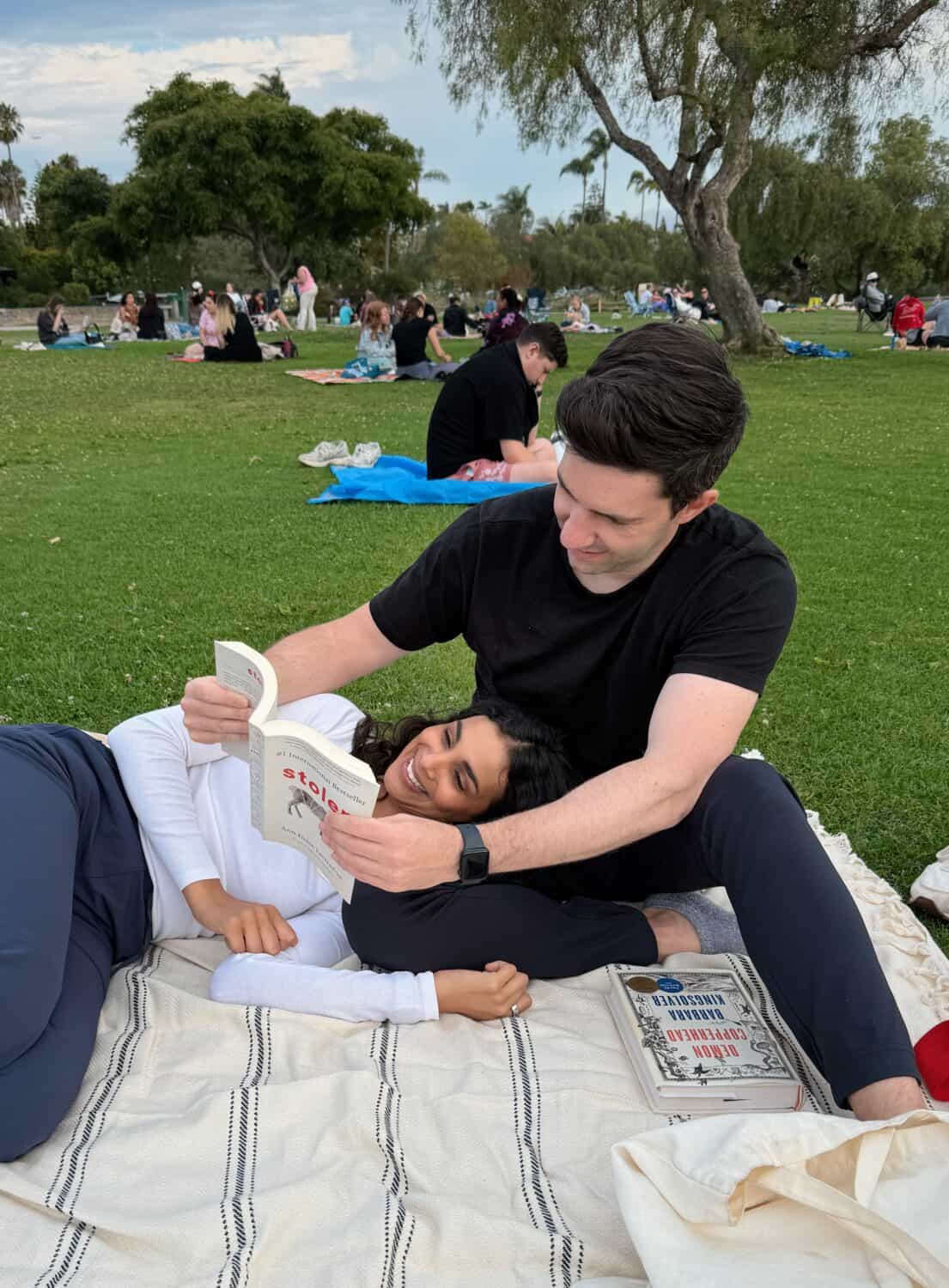 Nisha and Max reading in the park