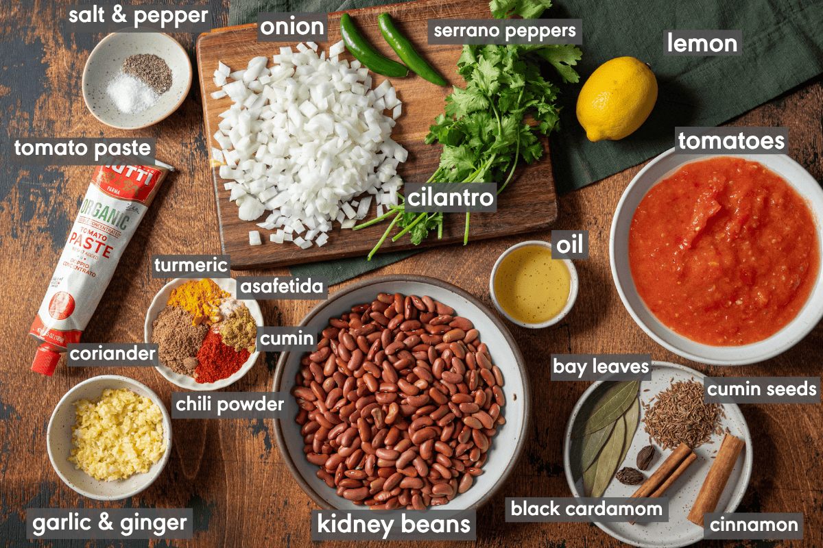 rajma masala ingredients on a cutting board and in various small bowls on a table.