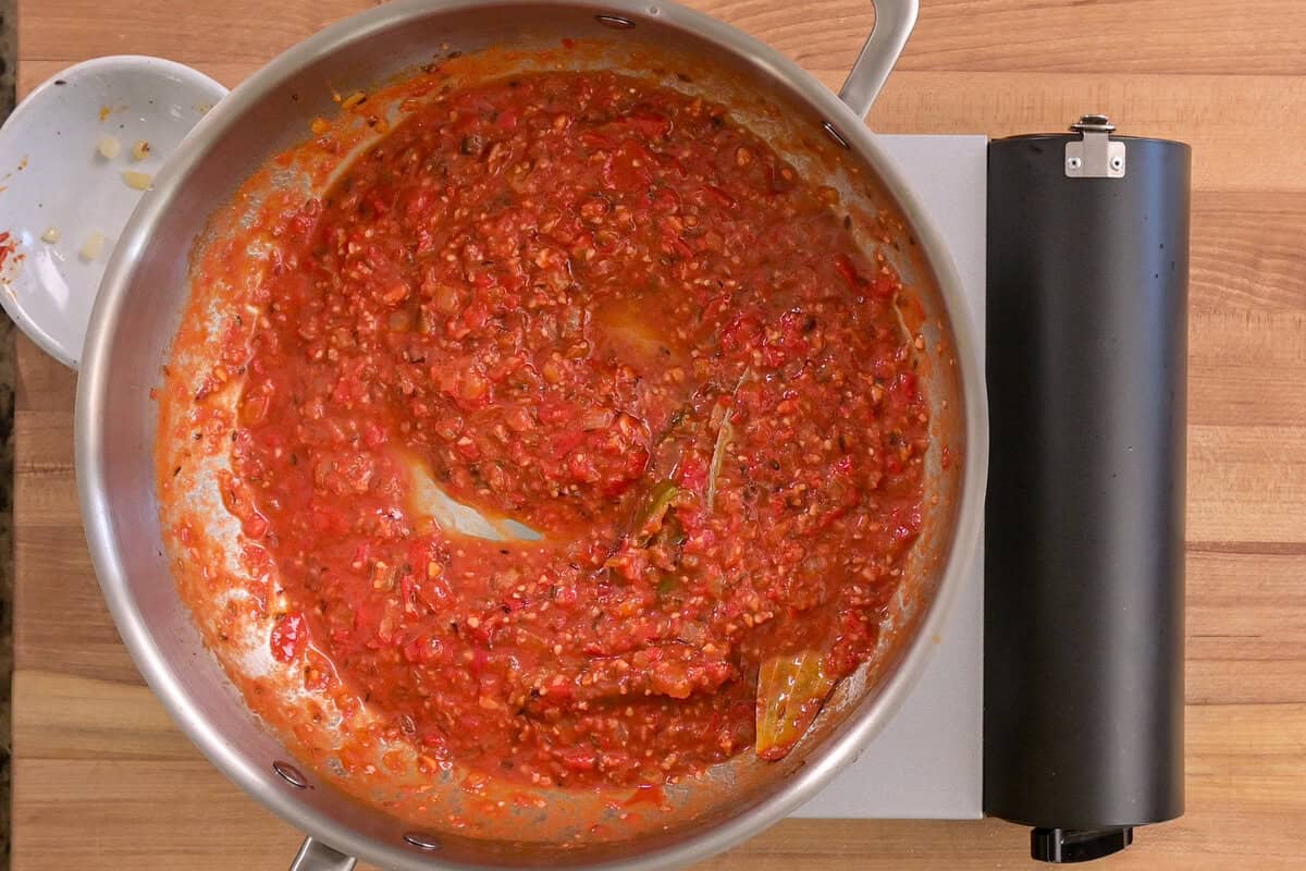 tomato puree, salt and pepper added to the frying pan.